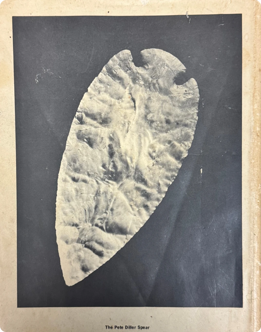 Ancient stone spearhead on dark background